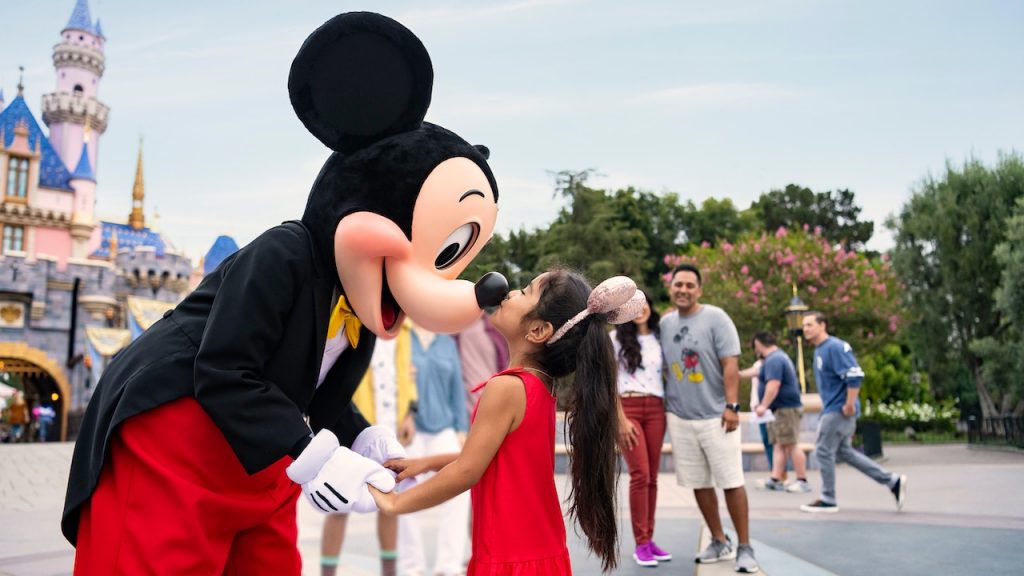Young guest meeting Mickey Mouse at Disneyland part